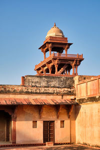 Low angle view of historical building against clear blue sky