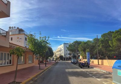 Street amidst buildings in city against sky