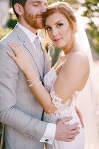 Midsection of bride and bridegroom holding hands