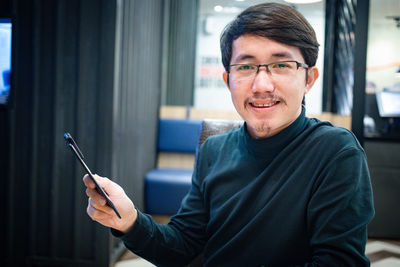 Portrait of young man using mobile phone