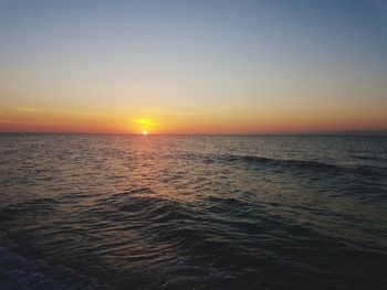 Scenic view of sea against clear sky during sunset