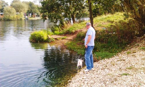 Full length of man walking by river