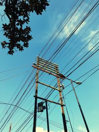 Low angle view of electricity pylon against sky