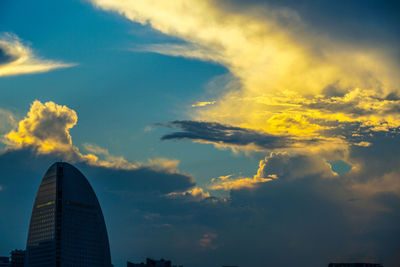 Low angle view of buildings against sky during sunset