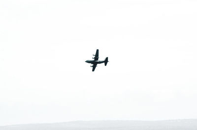Low angle view of airplane against clear sky