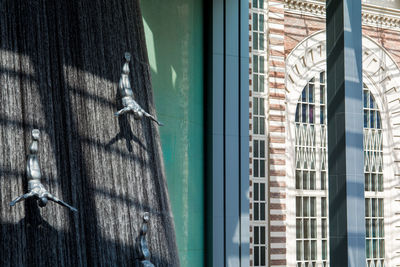 Metallic sculpture on wood by window at home