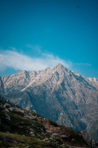 Scenic view of mountains against blue sky