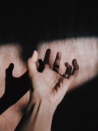 High angle view of human hand on wood