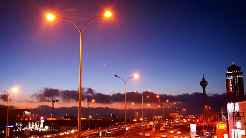 Illuminated street lights in city at night