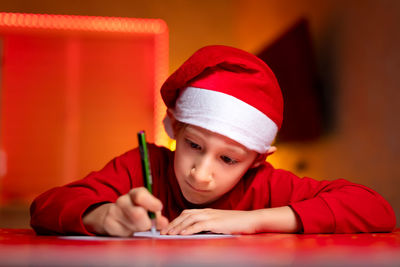 Portrait of cute boy wearing hat at home