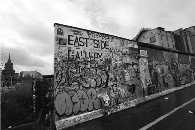 Graffiti on wall against sky