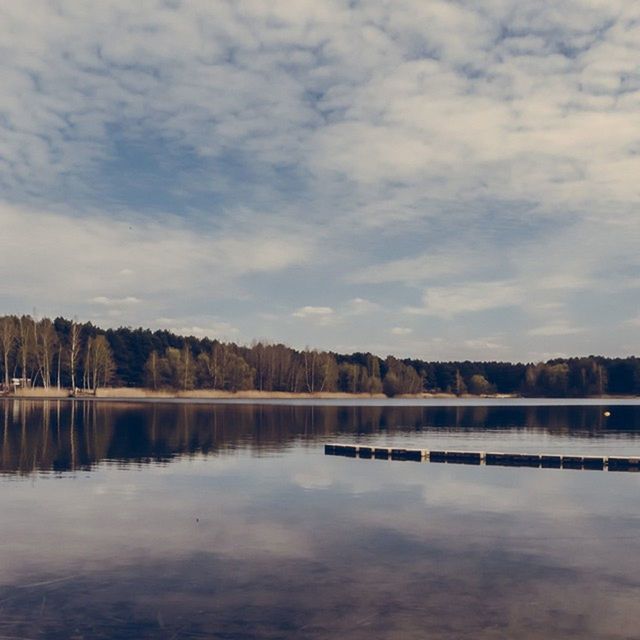 water, lake, tranquility, tranquil scene, reflection, sky, tree, scenics, beauty in nature, waterfront, cloud - sky, nature, pier, calm, idyllic, river, standing water, cloud, non-urban scene, cloudy