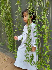 Girl standing by plants