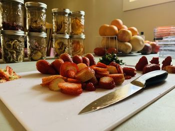 Cutting fruit with canned fruit in the background