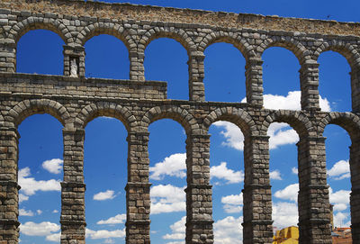 Low angle view of aqueduct of segovia against sky