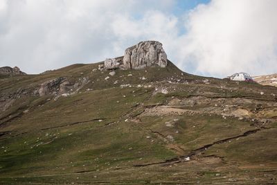 Scenic view of mountains against cloudy sky