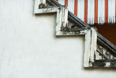 Low angle view of window on wall of old building