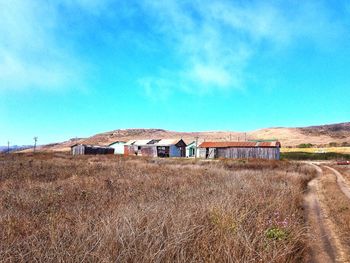 Houses on field against sky