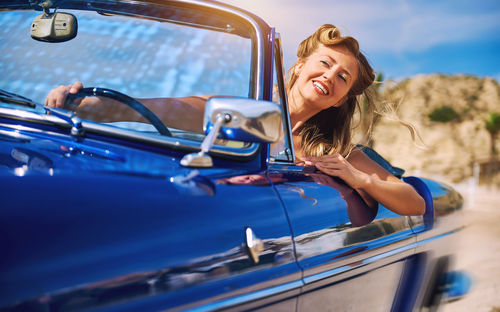 Portrait of happy young woman in car