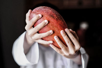 Close-up of woman holding fruit