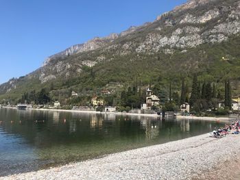 Scenic view of lake by mountains against sky