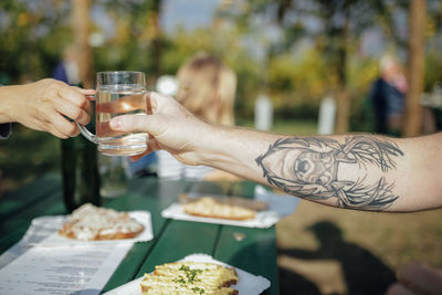 Midsection of man drinking glass