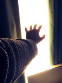 Close-up of hand on window