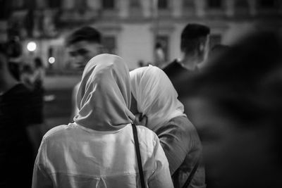 Rear view of people walking on street