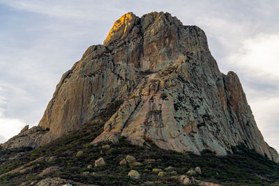 Low angle view of rock formation against sky