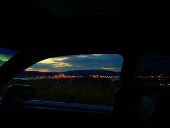 Illuminated cityscape at sunset