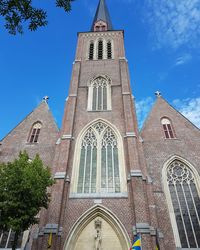 Low angle view of church against blue sky