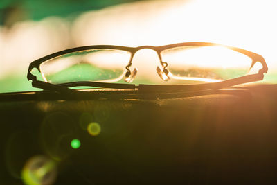 Close-up of sunglasses under sunset