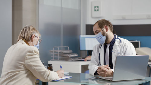 Female doctor examining patient in clinic