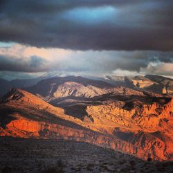 Scenic view of mountains against cloudy sky