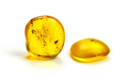 Close-up of yellow eggs against white background