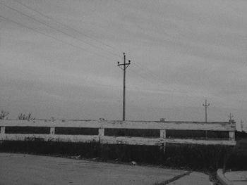 Low angle view of telephone pole against sky