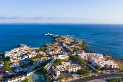 High angle view of townscape by sea against sky