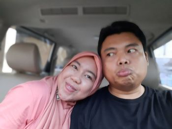 Portrait of friends sitting in car