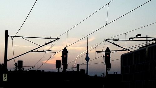 Low angle view of power lines against sky