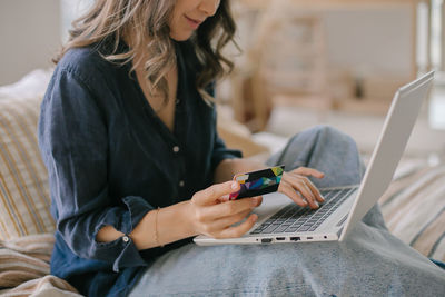 Midsection of woman using mobile phone