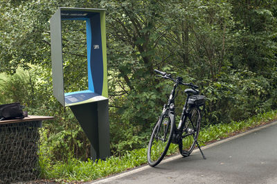 Bicycle parked by trees