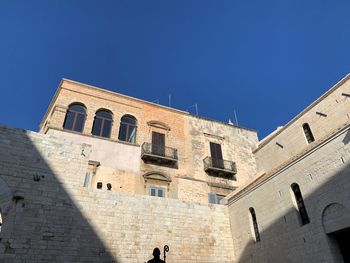 Low angle view of building against clear blue sky