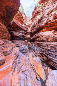 Rear view of man climbing on rock formations