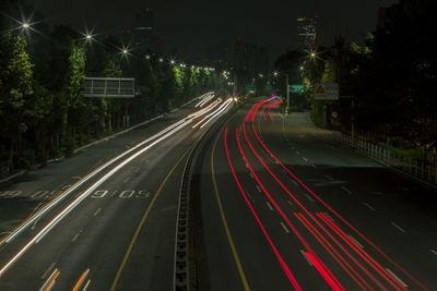 High angle view of light trails on road at night