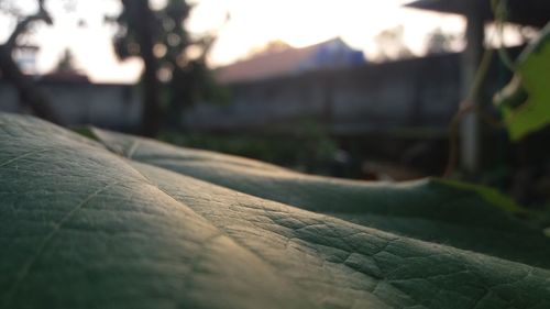 Surface level of footpath against sky during sunset