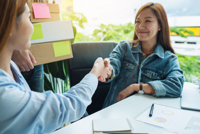 Close-up of business colleagues working at office