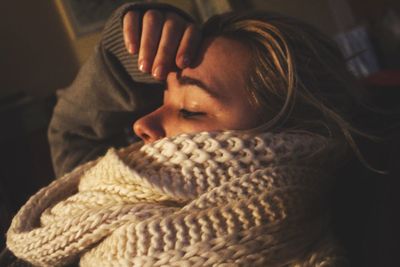 Close-up of woman wrapped in scarf at home