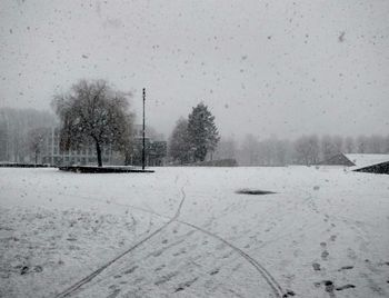 Snow covered landscape against sky