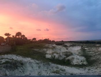 Scenic view of field against sky during sunset