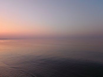 Scenic view of sea against clear sky during sunset